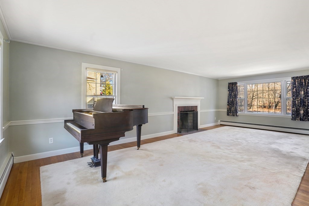 61 Walnut Street Shrewsbury, MA 01545 - Photo 7 of 38 a view of a livingroom with furniture and a fireplace