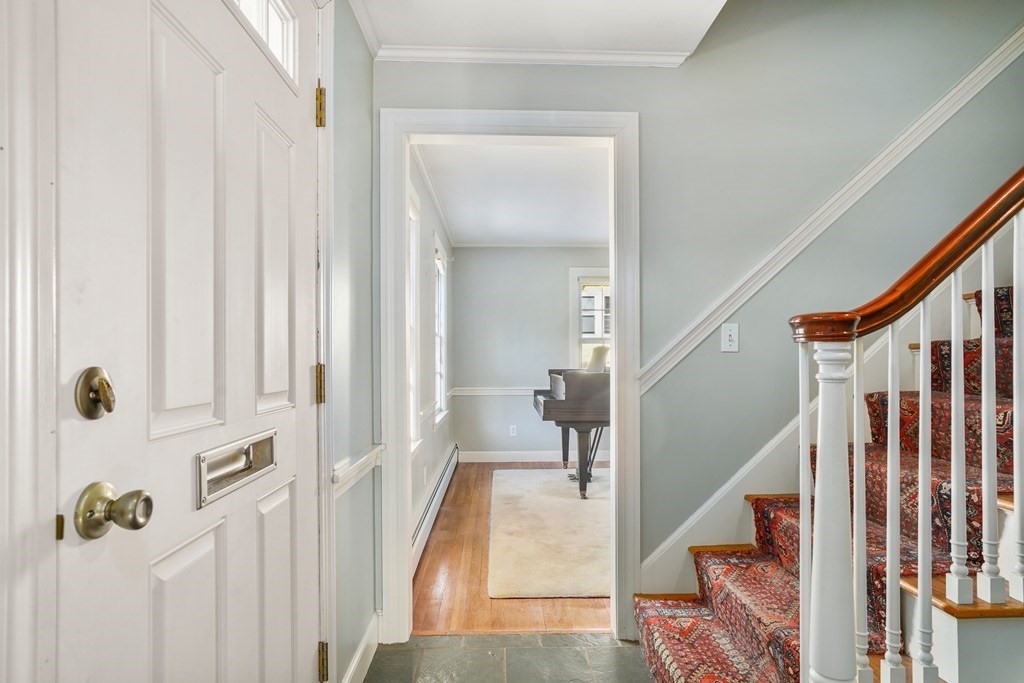 61 Walnut Street Shrewsbury, MA 01545 - Photo 10 of 38 a view of a hallway with wooden floor and staircase