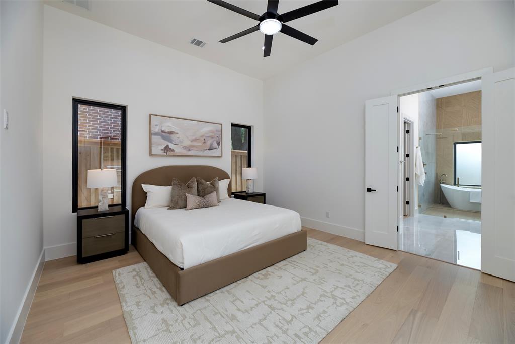 6038 Prospect Avenue Dallas, TX 75206 - Photo 11 of 40 a bedroom with a large bed and ceiling fan