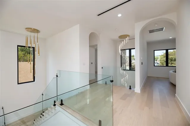a view of an entryway with wooden floor and a mirror
