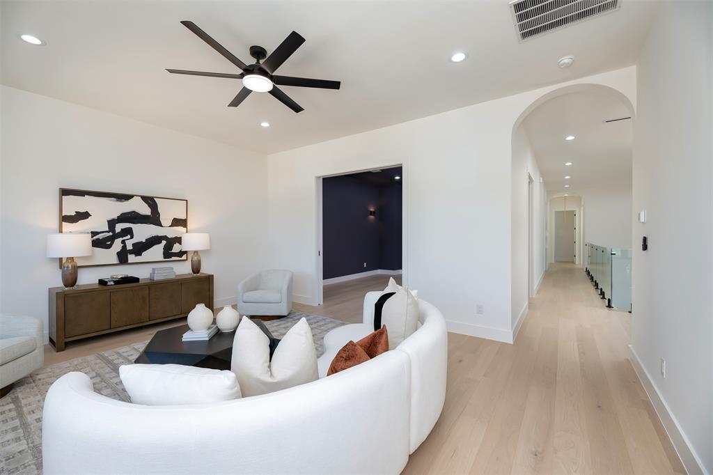 6038 Prospect Avenue Dallas, TX 75206 - Photo 22 of 40 a living room with furniture and a chandelier