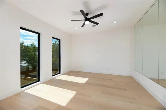 a view of a livingroom with a ceiling fan and window