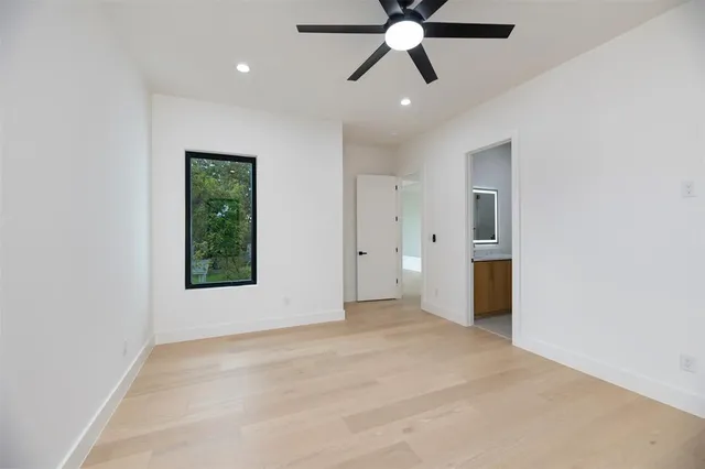 an empty room with fan and windows