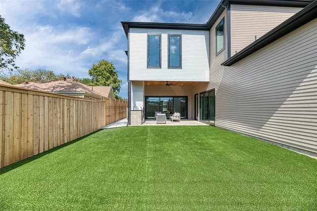 a view of a house with backyard and porch