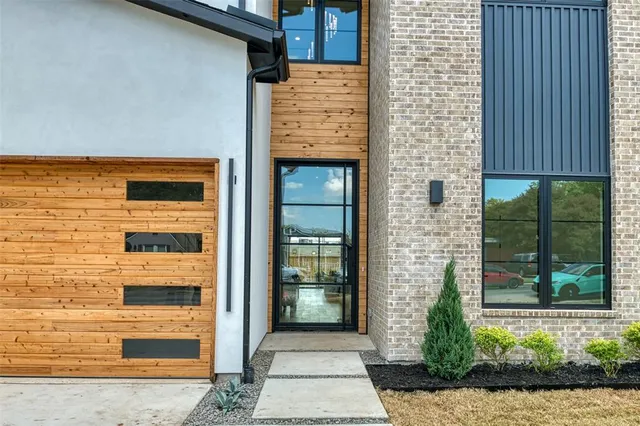 a view of a brick house with a large window
