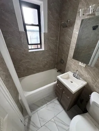 a bathroom with a sink a toilet and bathtub