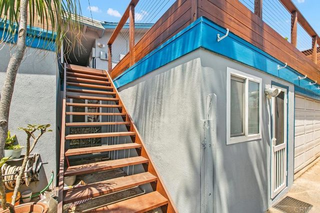 a view of a building with stairs and a front door