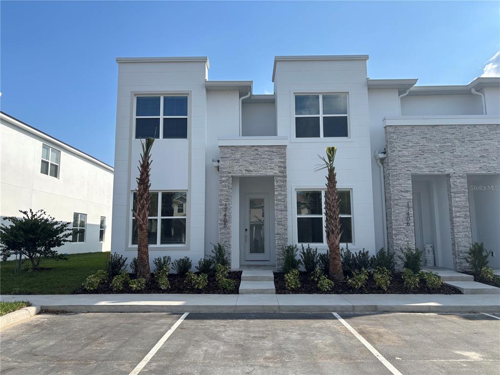 17408 Serenidad Boulevard Clermont, FL 34714 - Photo 1 of 1 front view of a brick house with a yard