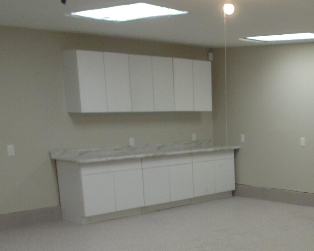 2919 State Street Lake Station, IN 46405 - Photo 24 of 28 a kitchen with white cabinets and a sink