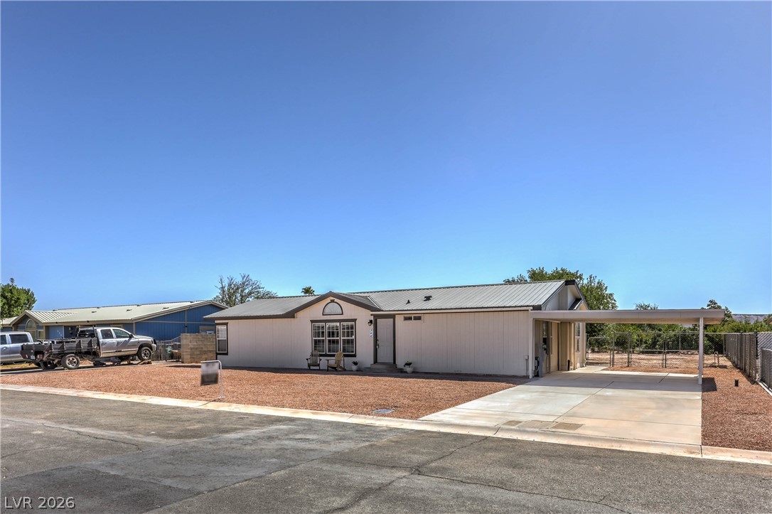 348 Tres Palomas Street Overton, NV 89040 - Photo 2 of 41 A well-maintained facade with a covered carport awaits, offering practical curb appeal.