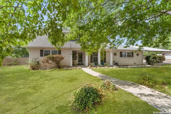 a house that has a tree in front of it