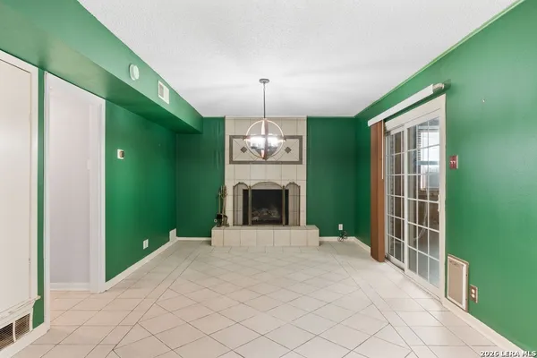 a view of a hallway with a chandelier and entryway