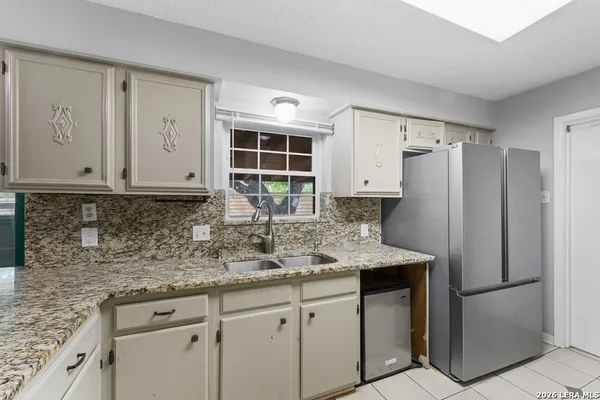 a kitchen with a sink and cabinets
