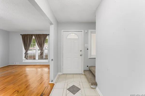 an empty room with windows and closet