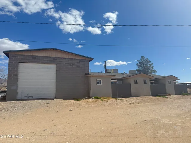 a bedroom with a bed dresser and a chandelier