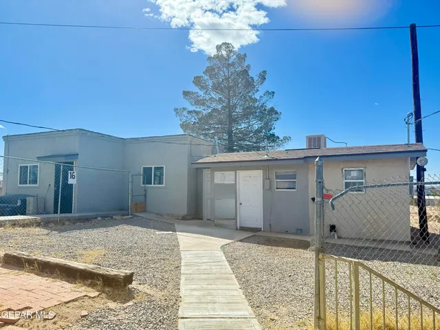 a view of a house with a snow in the background