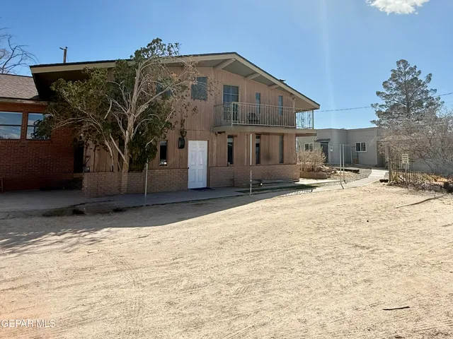 a view of a house with snow on the road
