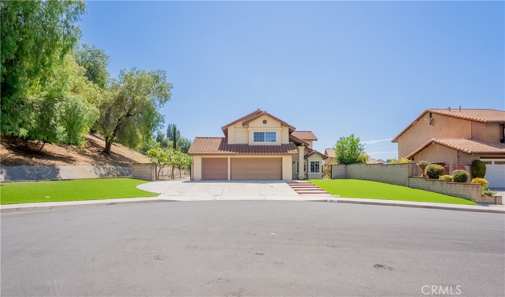 703 Pinto Circle Walnut, CA 91789 - Photo 2 of 54 a front view of a house with a yard and garage