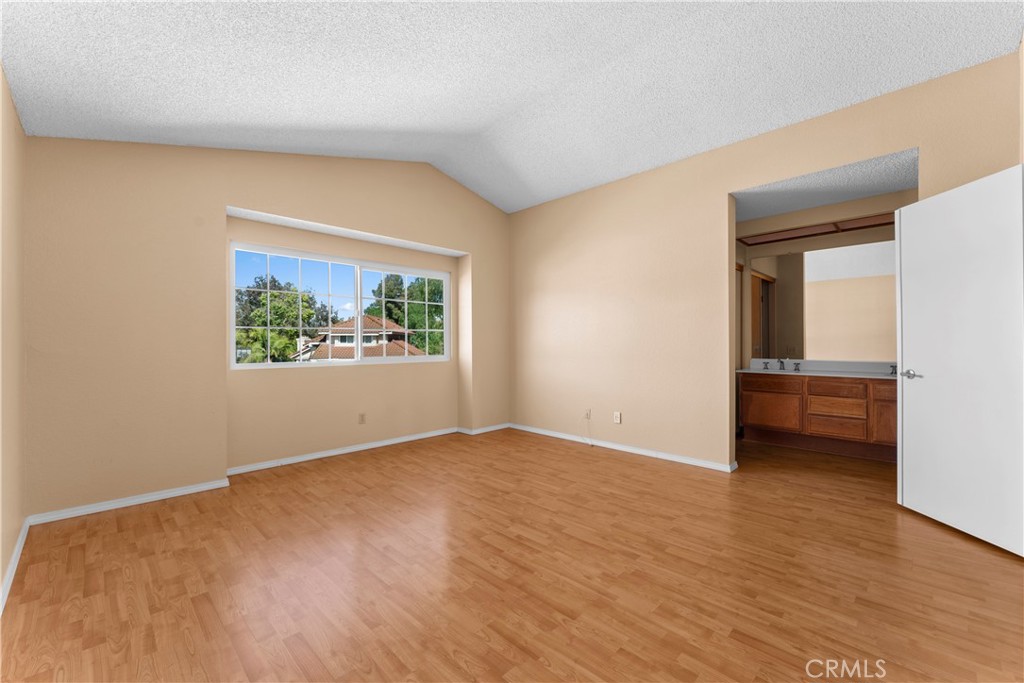 703 Pinto Circle Walnut, CA 91789 - Photo 23 of 54 a view of an empty room with wooden floor and a window