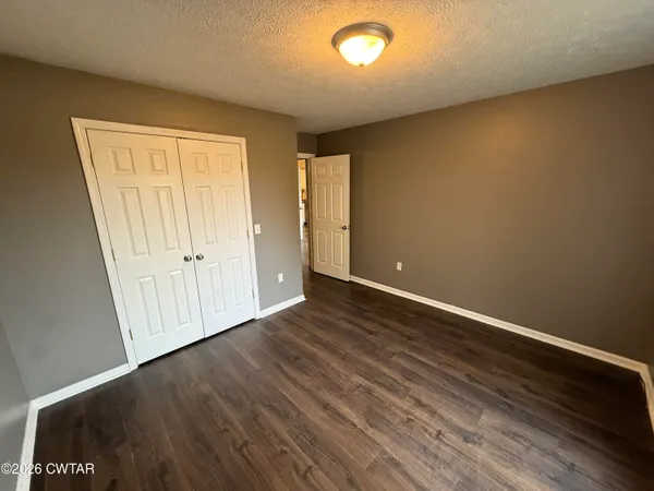 an empty room with wooden floor