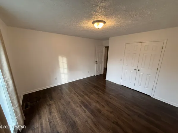 a view of an empty room and wooden floor