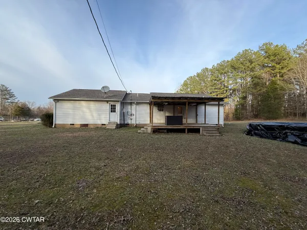 a view of a house with a yard and tree