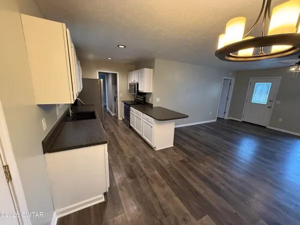 a view of a kitchen with a sink and a stove