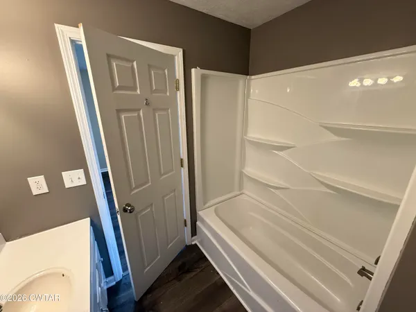 a bathroom with a tub and shower