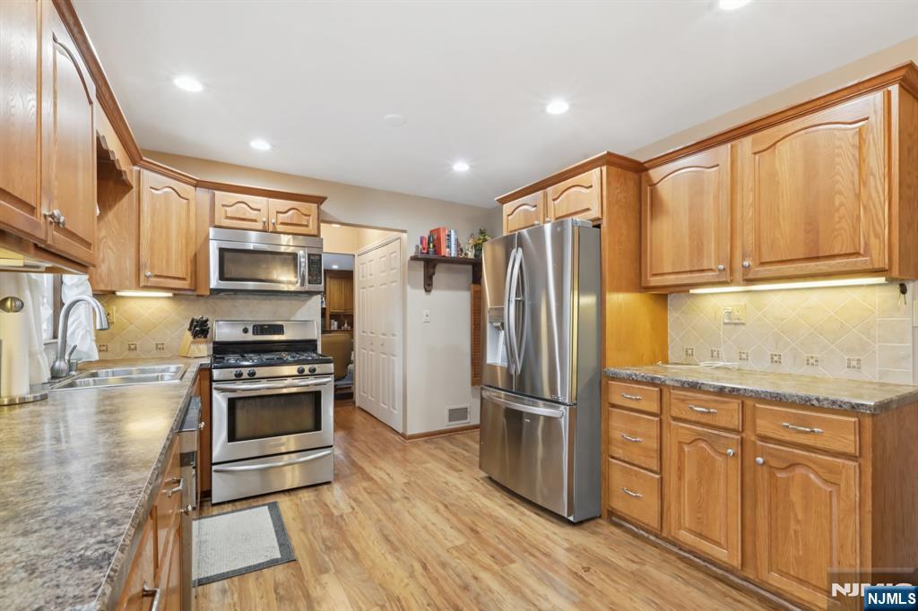 29 Joyce Drive Roxbury Township, NJ 07876 - Photo 12 of 31 a kitchen with stainless steel appliances granite countertop a refrigerator stove and sink