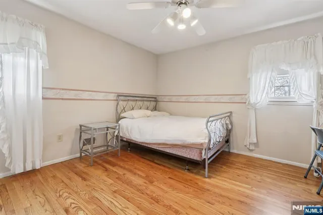 a bedroom with a bed and a wooden floor