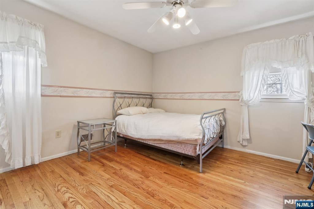 29 Joyce Drive Roxbury Township, NJ 07876 - Photo 20 of 31 a bedroom with a bed and a chandelier