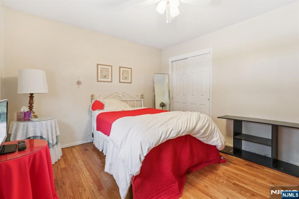 29 Joyce Drive Roxbury Township, NJ 07876 - Photo 21 of 31 a bedroom with a bed and a wooden floor