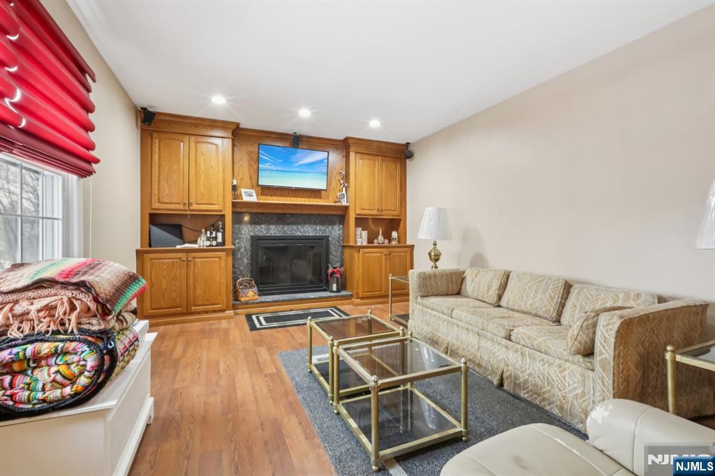 29 Joyce Drive Roxbury Township, NJ 07876 - Photo 6 of 31 a living room with furniture a flat screen tv and a fireplace