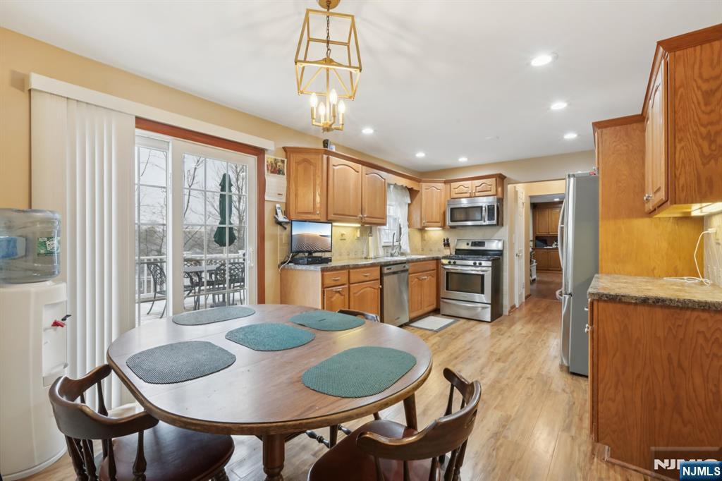 29 Joyce Drive Roxbury Township, NJ 07876 - Photo 9 of 31 a open kitchen with stainless steel appliances granite countertop a dining table chairs and refrigerator
