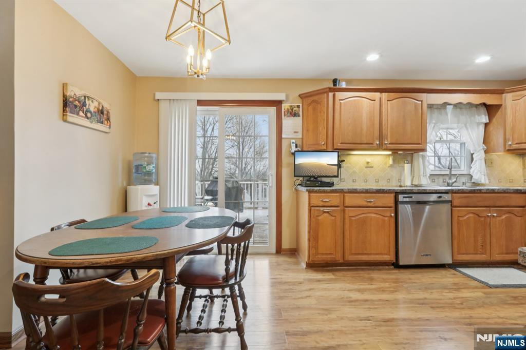 29 Joyce Drive Roxbury Township, NJ 07876 - Photo 10 of 31 a kitchen with granite countertop a dining table chairs and white cabinets