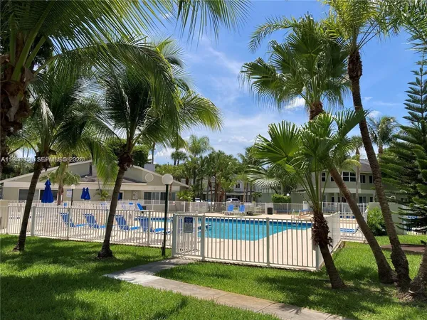 a view of a park with a palm trees