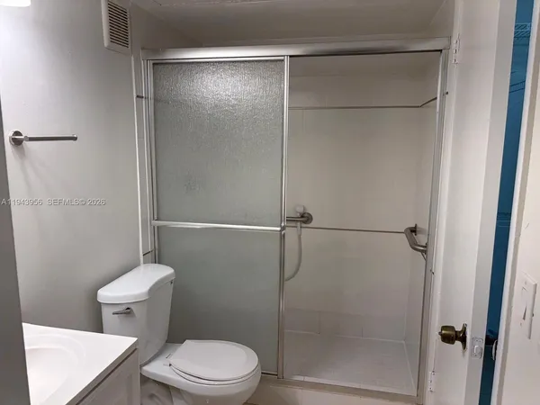 a bathroom with a shower and a toilet