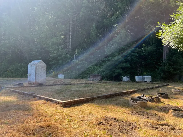 a view of a wooden house with a yard