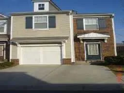 a front view of a house with yard