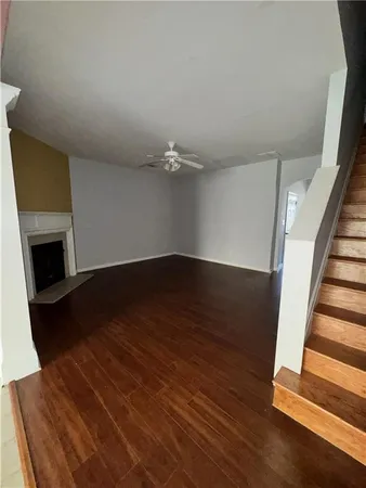 wooden floor in an empty room with a fireplace