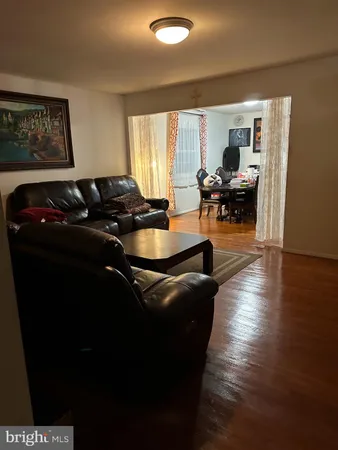 a living room with furniture rug and a large window