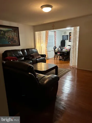 a living room with furniture rug and a large window