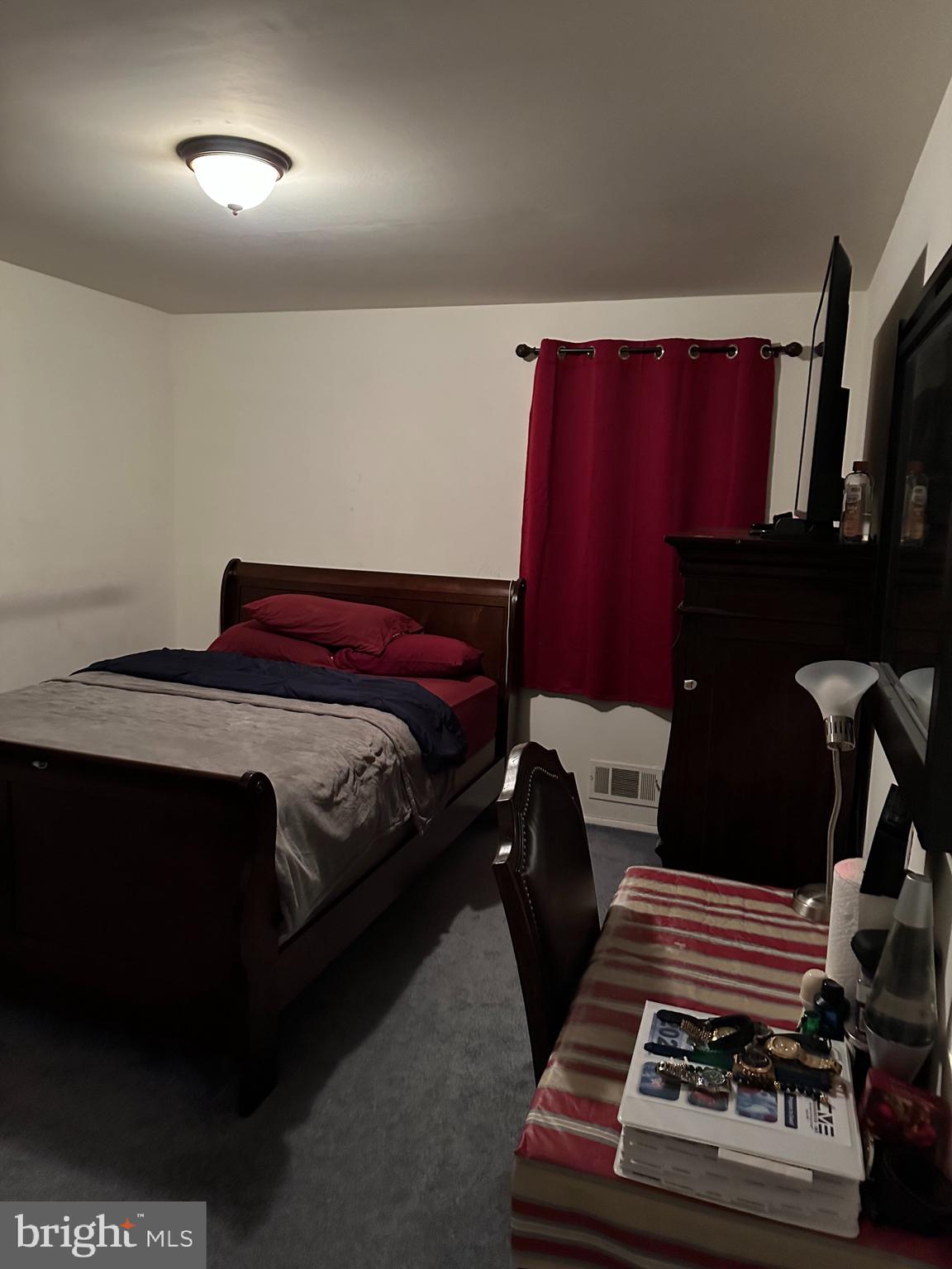 9072 Meadow Heights Road Randallstown, MD 21133 - Photo 5 of 16 a bedroom with a bed and a black mirror