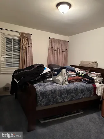 a bedroom with a bed and walk in closet