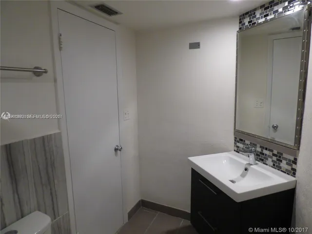 a bathroom with a sink toilet and vanity