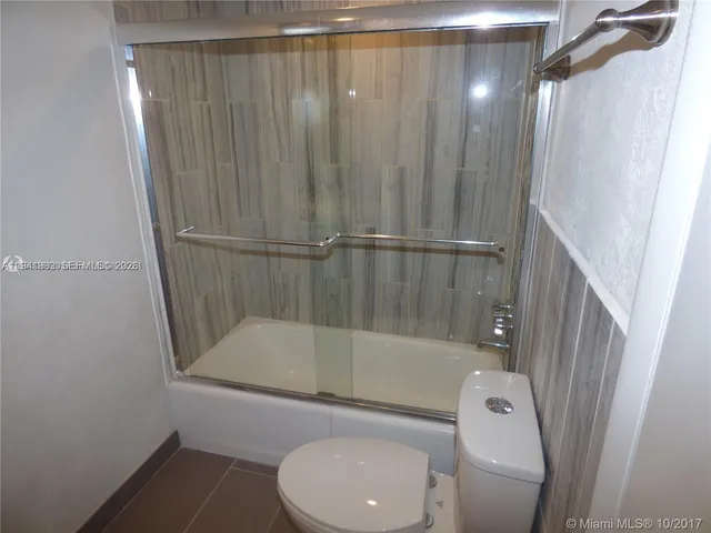 a bathroom with a toilet and a bathtub