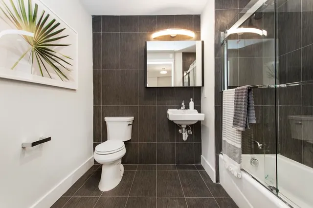 a bathroom with a toilet a sink and mirror