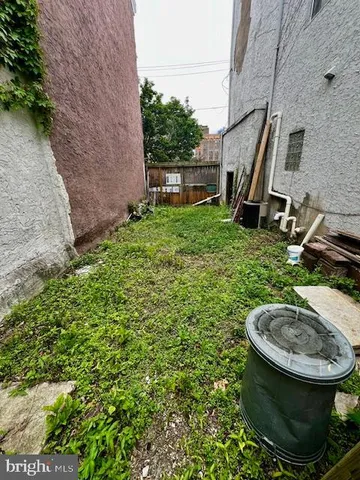 a view of a backyard with plants and entertaining space