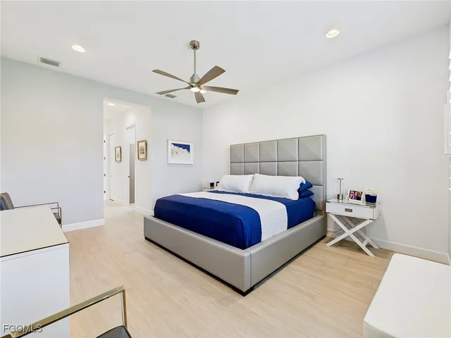 a bed room with a bed and a ceiling fan