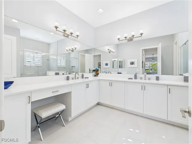 a spacious bathroom with a double vanity sink mirror and